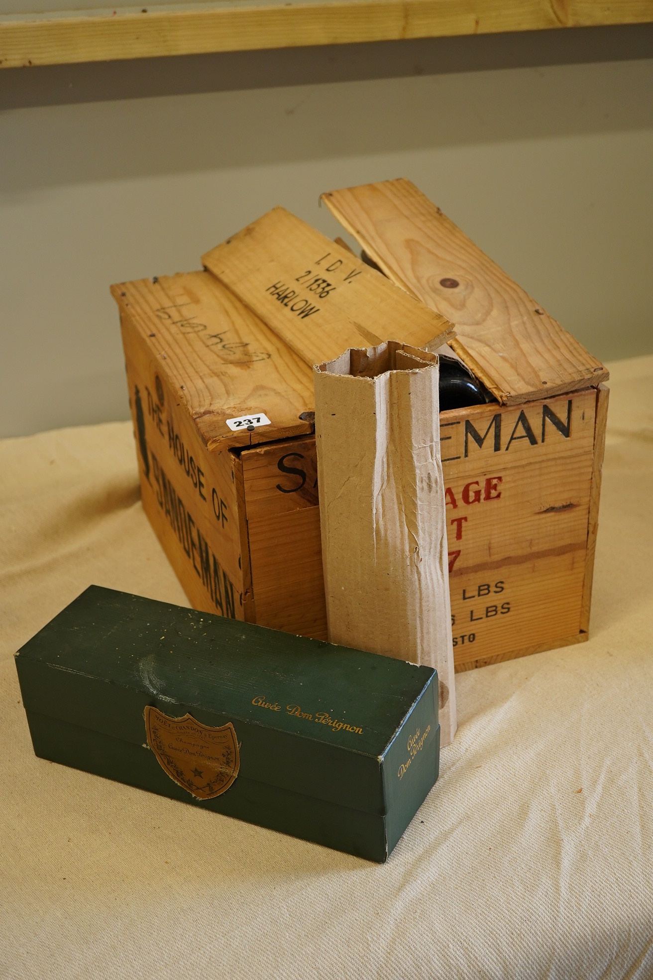 Twelve bottles of 1977 Sandeman vintage port (O.W.C but opened), and a cased bottle of 1978 Dom Perignon champagne